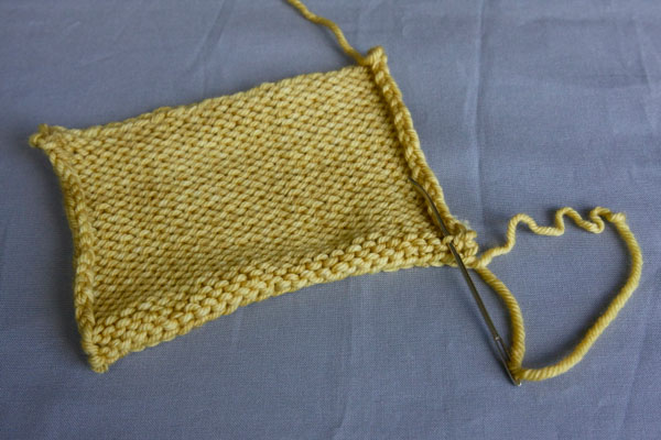 Weave the end through the stitch
