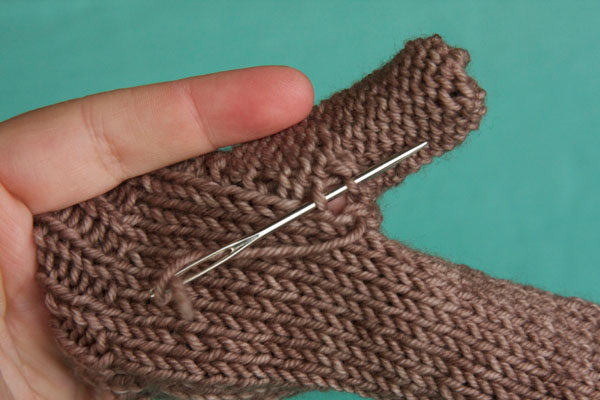 Turn the mitten inside out and sew up the hole with your tail.