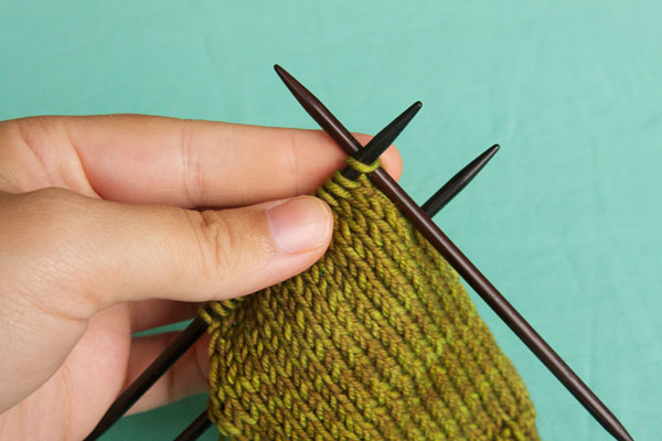 Insert your right needle into the first stitch on the left needle as if to knit