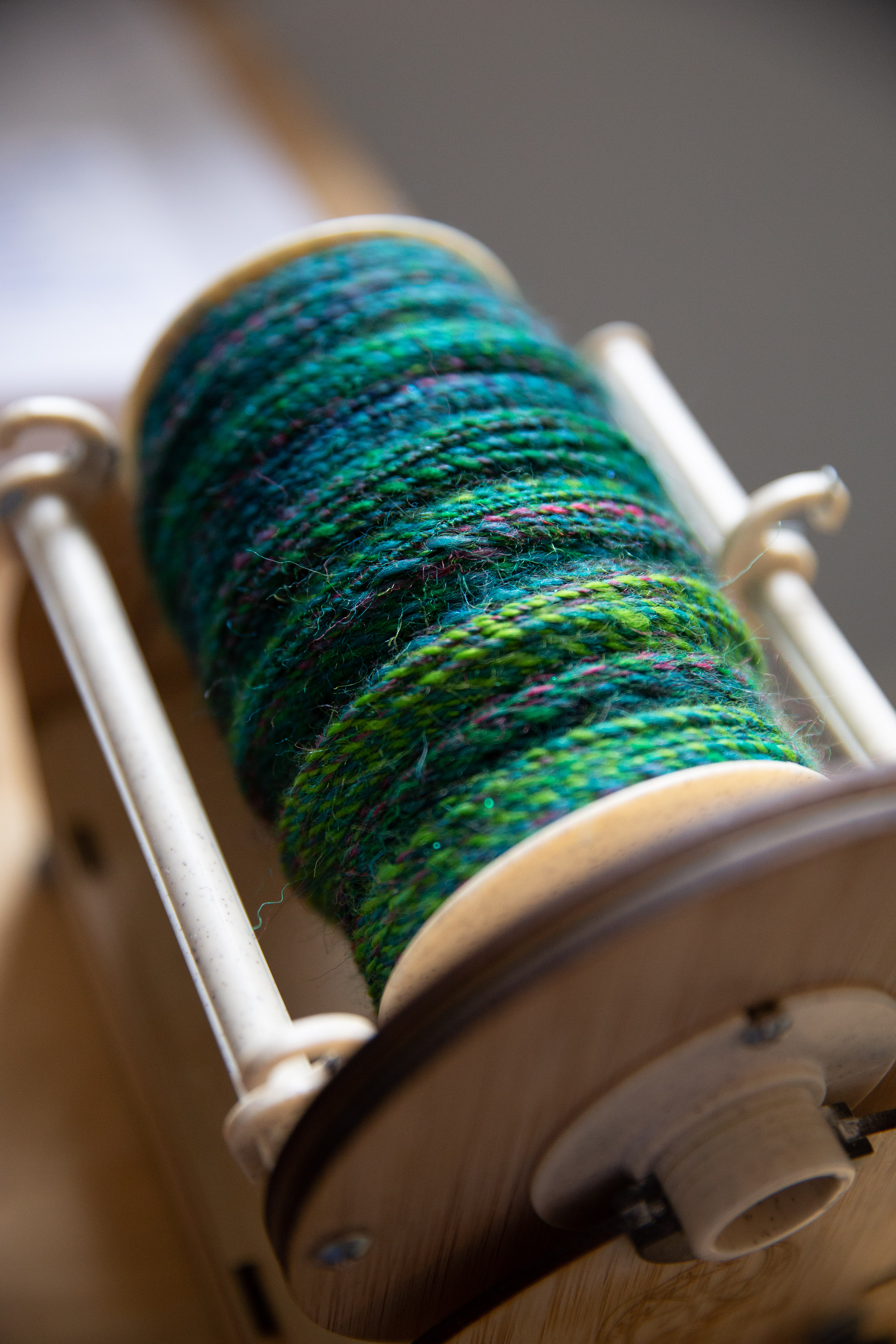 green and teal 2ply handspun on an e-spinner