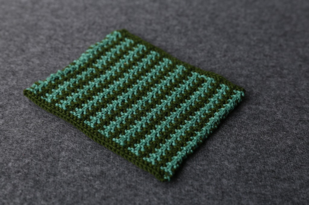 A green swatch. It is dark green with light green vertical stripes. 